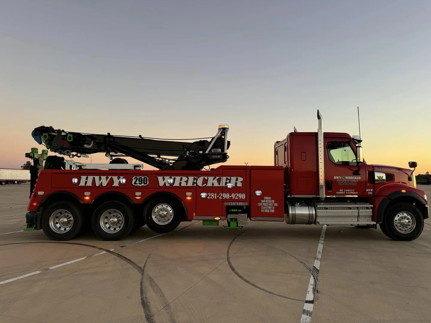 HWY 290 Wrecker heavy-duty rotator truck at sunset